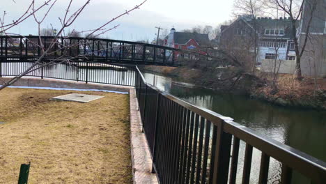 Close-up-Cinematic-4-K-footage-of-a-black-iron-fence-over-a-river-on-a-winter-day