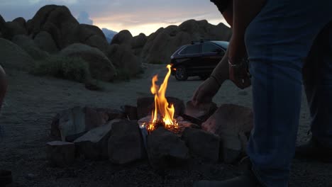Flames-of-Campfire,-People-and-Car-in-Wilderness-of-Alabama-Hills,-California-USA