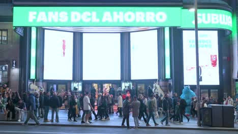 View-of-Madrid-nighttime-as-pedestrians-and-clients-are-seen-at-the-Capitol-Theater-and-cinema-entrance-at-Gran-Via-Street,-known-for-its-numerous-entertainment-offerings-for-tourists-and-others