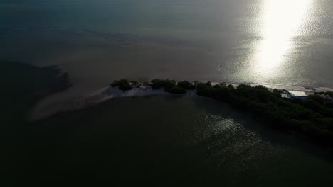 High-altitude-aerial-with-low-angle-sunshine-over-Holbox,-an-island-in-the-Mexican-state-of-Quintana-Roo,-located-on-the-north-coast-of-the-Yucatán-Peninsula