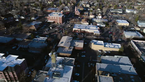 Downtown-Flagstaff-AZ-USA,-Aerial-View-of-Streets,-Buildings-and-Catholic-Church-Revealing-Drone-Shot