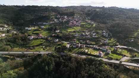 Sunlight-glistens-on-scenic-town-of-Cebolino-in-ourense,-galicia,-spain,-Aerial-establish-pan