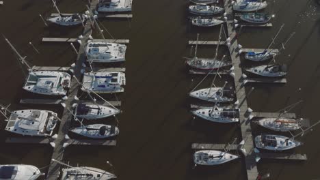 A-top-down-aerial-view-of-sailboats-in-their-slips-at-Kemah-Marina-in-Kemah,-Texas