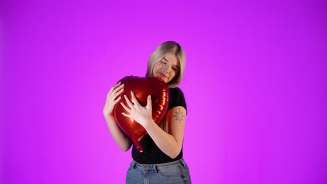 Concept-someone-gives-his-heart-to-a-woman,-hugging-in-love,-studio-shot