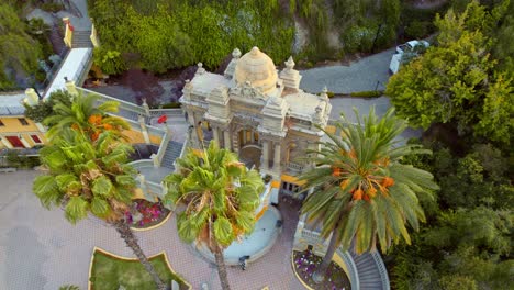 Neptuno-fountain-at-santa-lucía-hill,-surrounded-by-lush-greenery-in-santiago,-aerial-view