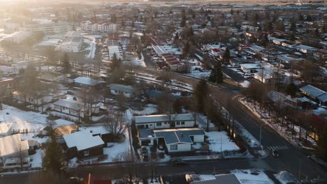 Aerial-flight-over-driving-cars-ons-street-in-Icelandic-town