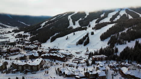 Copper-Mountain-Colorado-ski-resort-foggy-cloud-layer-winter-snowy-early-morning-sunrise-aerial-drone-i70-Eagle-Flyer-lift-center-village-half-pipe-Ikon-pass-snowboarding-forward-slowly-pan-upward