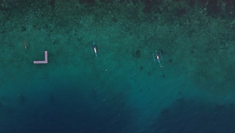 Paddle-boarders-on-the-clear-waters-of-oslob-island,-philippines,-tranquil-ocean,-aerial-view