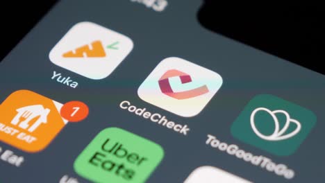 Close-up-of-swiping-on-smartphone,-Codecheck-app-in-focus,-tech-lifestyle