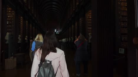 Camera-following-young-girl-unveils-the-Long-Room-at-Trinity-College-Old-Library