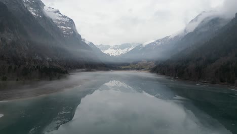 Klöntalersee-Glarus-Switzerland-serene-beauty-flying-under-mist-above-mirror-lake