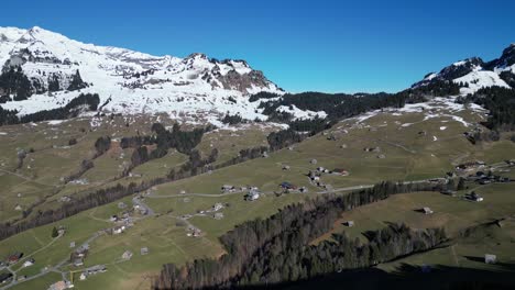 Amden-Weesen-Switzerland-slow-flight-over-green-valley-village-in-the-Alps