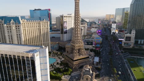 Aerial-view-rising-toward-the-Eiffel-Tower,-sunrise-at-the-Las-Vegas-Strip