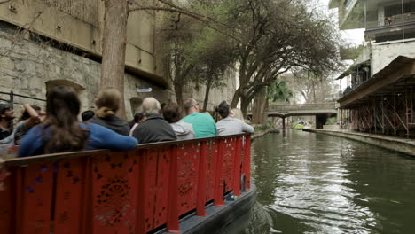 Tour-Boat-Passes-on-River-Walk-in-San-Antonio,-Texas,-USA