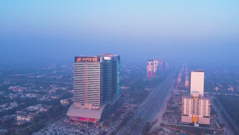 Aerial-view-of-Islamabad,-Centaurus-Mall-during-winter-in-the-evening-with-dense-fog,-Islamabad,-Pakistan