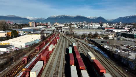 Industrial-Freight-Trains-Transporting-Intermodal-Containers-At-Railyard-In-Canada