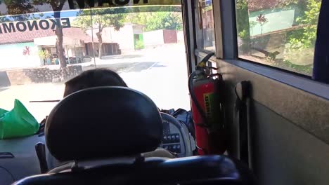 Pov-from-inside-a-bus-heading-to-Ngawi,-east-java-from-Blora,-Central-Java,-in-Indonesia