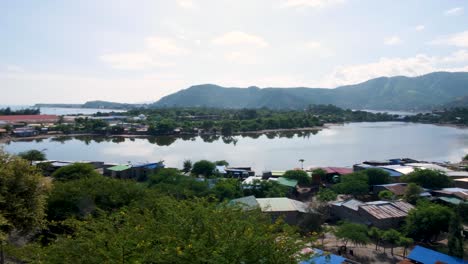 Scenic-landscape-view-of-community-houses-surrounding-Tasitolu-wetlands-saline-lakes-in-the-capital-city-of-East-Timor,-Southeast-Asia