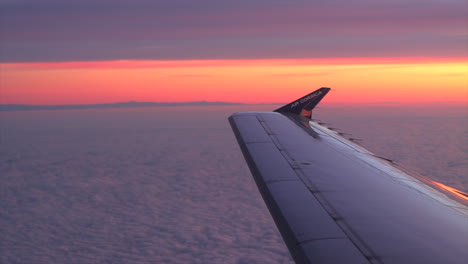 Wing-and-winglet-of-Air-Corsica-jet-against-brilliant-sunset-in-mid-flight