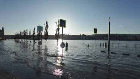 Slow-Motion---Flooded-crosswalk-at-the-House-of-Parliament-in-Budapest-with-the-Royal-Castle-of-Buda-in-the-background-during-the-flood-of-Danube-River,-Hungary---December-28,-2023