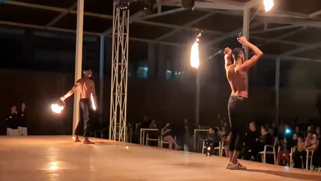 Fire-performers-doing-poi-show-in-front-of-audience