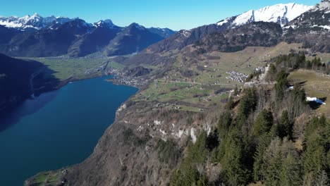Amden-Weesen-Switzerland-wide-swivelling-reveal-of-the-area-with-lake-town-and-mountains