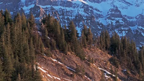 Aerial-view-at-dawn-displaying-the-silhouette-of-a-snow-covered-mountain-range