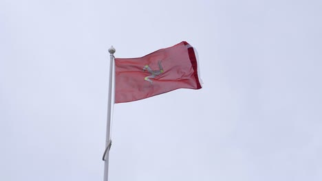 Isle-of-Man-State-and-Civic-Flag-Waving-on-Pole-in-Douglas-City