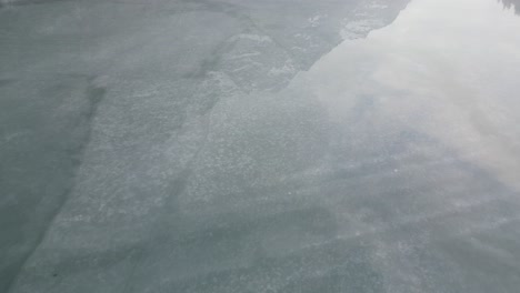 Klöntalersee-Glarus-Switzerland-aerial-of-ice-lake-with-water-on-top-offers-perfect-reflection