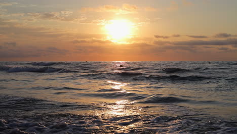 Beautiful-Sunrise-View-From-Beach-Shore-of-Calm-Sea-in-Valencia-Spain