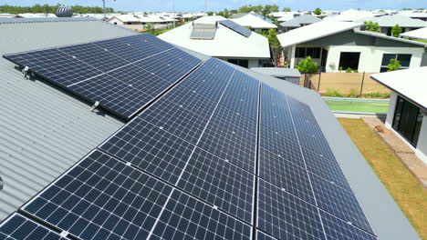 Aerial-drone-of-ESG-Solar-Panels-On-Corrugated-Roof-of-House-In-Newly-Built-Neighbourhood