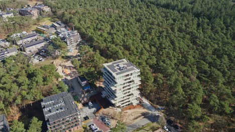 Aerial-of-beautiful-newly-built-apartment-building-with-photovoltaic-solar-panels-on-rooftop