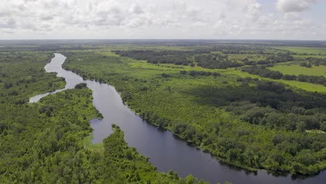 Aerial-view-of-large-river-in-Florida-farmland-that-connects-to-Lake-Okeechobee