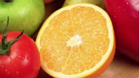 Close-up-macro-of-colorful-fruits-and-vegetables-rotating-on-a-wooden-board