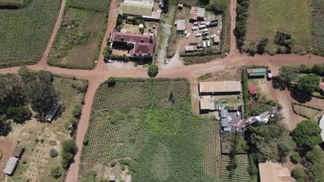 Poor-African-rural-neighbourhood,-buildings,-fields-and-radio-tower-aerial-view