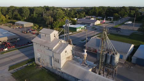 Old-grain-silos-in-Clare,-Michigan,-USA---small-rural-town-in-aerial-view