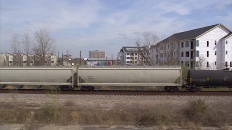 Drone-view-of-new-housing-construction-as-train-passes-by