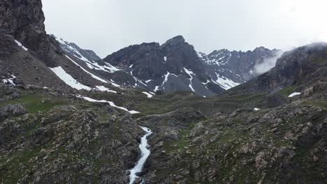 Mountain-waterfall-flowing-through-rocky-terrain-at-Cascata-di-Stroppia-near-Lago-Niera,-overcast-weather
