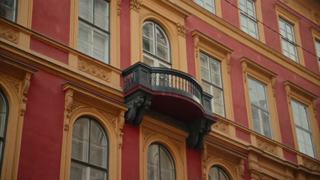 Small-balcony-of-an-old-residential-building,-Exterior-of-a-beautifully-renovated-historic-apartment-building-in-Budapest,-Hungary,-Hungarian-architecture,-colourful-facade,-large-windows,-urban,-city