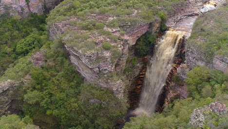Aerial-view-of-a-waterfall-and-a-river-in-the-middle-of-a-big-vegetation,-Chapada-Diamantina,-Bahia,-Brazil