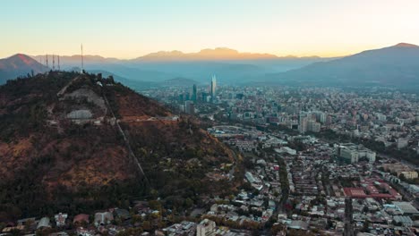 Aerial-hyperlapse-of-Santiago-skyline-with-Costanera-Tower-and-Andes-at-dawn,-city-waking-up