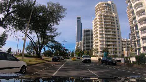 Point-of-view-driving-along-the-Esplanade-next-to-the-beach-through-Surfers-Paradise,-Gold-Coast