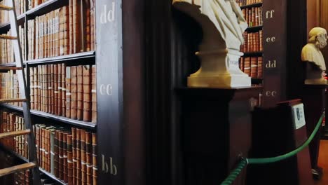 Philosophers-statues-bust-at-Trinity-College-Library-in-Dublin,-ascending-shot