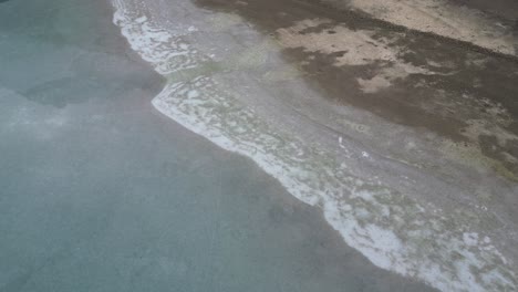 Klöntalersee-Glarus-Switzerland-icy-beach-reverse-flight