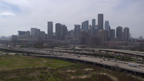 Drone-shot-of-downtown-Houston,-Texas-on-a-high-contrast-sunny-day