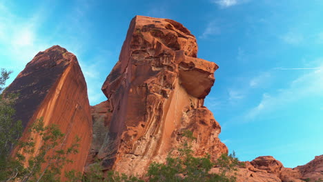 Pan-over-boulder-red-sandstone-rock-formation-with-bird-flying-in-National-Park-Valley-of-Fire-Bighorn-Sheep-Nevada-United-States-America-tourism