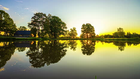 Timelapse-shot-of-an-overcast-sunrise-over-a-lake-view-along-the-rural-countryside-during-morning-time