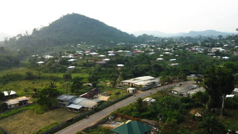 Ebolowa-city,-flying-over-streets-and-tropical-dwellings-in-southern-Cameroon---Aerial-view