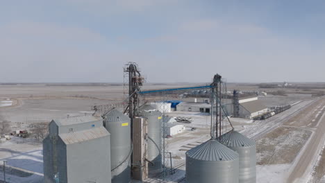 Aerial-View-of-Fertilizer-Plant-Beside-Snowy-Farm-Field