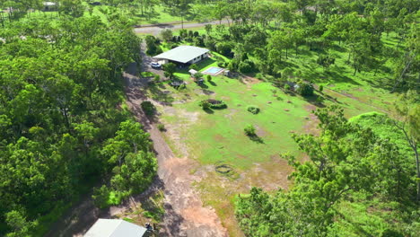 Aerial-drone-of-Exterior-of-Rural-Acreage-Block-with-House-and-Shed-Connected-by-Dirt-Road-Fly-Over